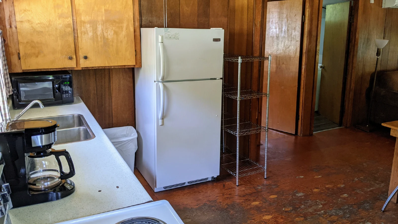 Pigeon Lake Resort Cottage three kitchen with sink, coffee maker, microwave, and refrigerator.